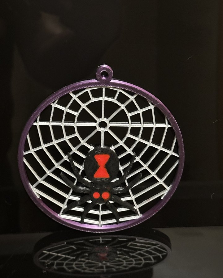 Midnight Widow: a silver web in a purple ring with a black widow whose hourglass and eyes are red